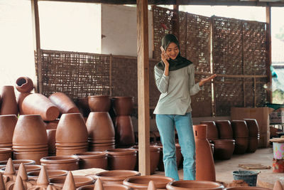 Portrait of young woman standing in store