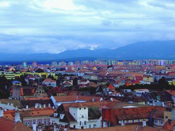 View of town against cloudy sky
