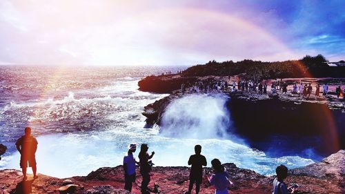 People enjoying in sea against sky