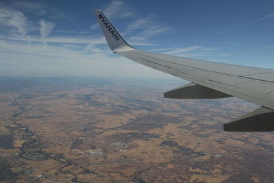 Aerial view of airplane wing over landscape