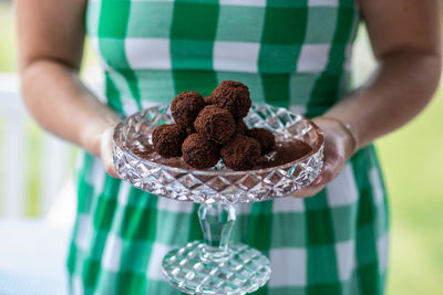 Midsection of woman holding cake