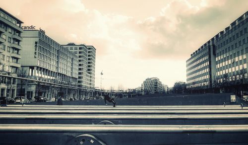 City street by buildings against sky
