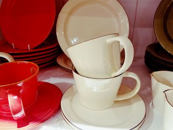 Close-up of cups and saucers on table