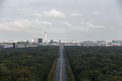 View of cityscape against cloudy sky