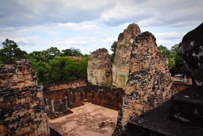 Old ruins of temple against cloudy sky