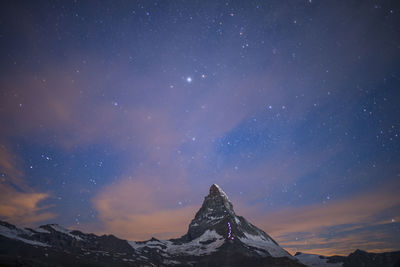 Scenic view of mountains against sky at night