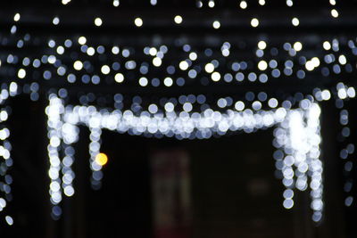 Low angle view of illuminated lights hanging from ceiling