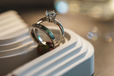 Close-up of wedding rings on table