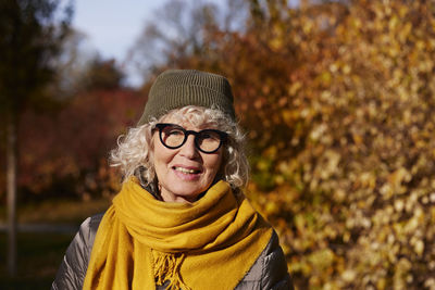 Portrait of senior woman in autumn scenery