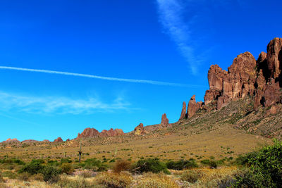 Scenic view of mountains against blue sky