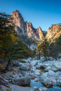 Scenic view of mountain against blue sky