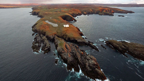 Aerial view of rock formations in sea