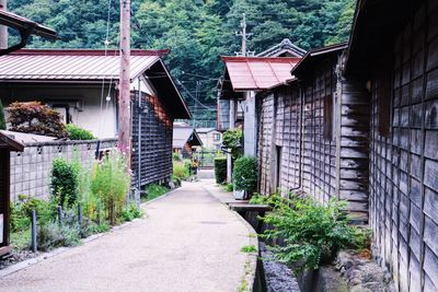 Footpath amidst buildings in city