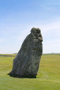 Scenic view of rocks on field against sky