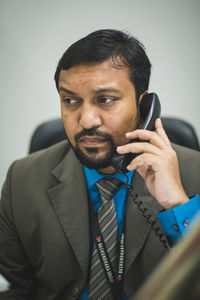 Portrait of young man using mobile phone