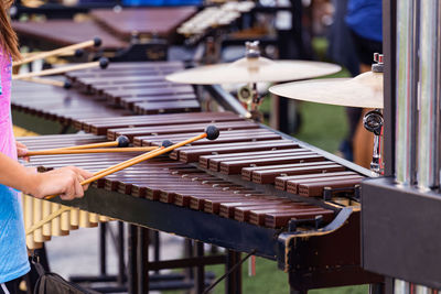 Several sideline percussionists performing at an evening outdoors rehearsal