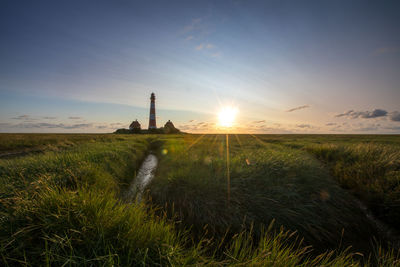 Scenic view of field against sky during sunset