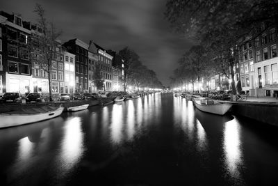 View of canal in city at night