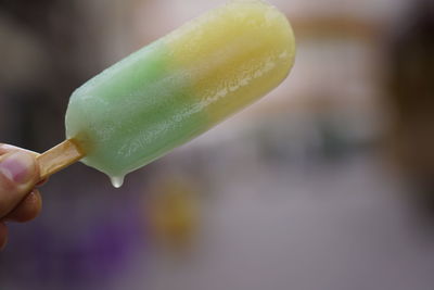 Close-up of hand holding ice cream