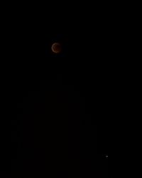 Low angle view of moon against sky at night