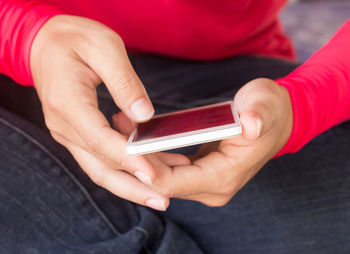 Midsection of man using mobile phone