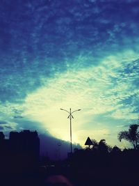 Silhouette of trees against cloudy sky