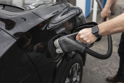 Man charging electric car