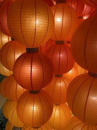 Low angle view of illuminated lanterns hanging from ceiling