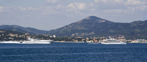 Scenic view of sea and mountains against sky