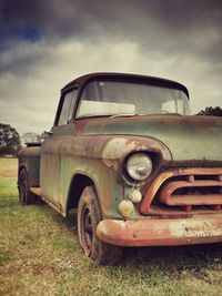 Abandoned car on field