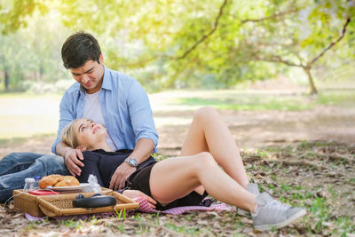 Young couple sitting on ground