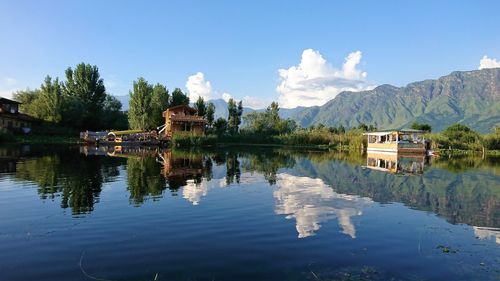 Scenic view of lake by building against sky