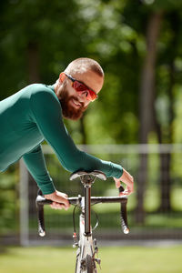 Portrait of young man riding bicycle