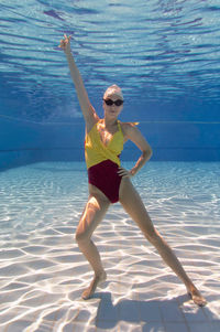 Portrait of young female model posing in pool