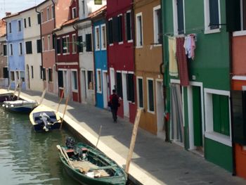 Boats in canal with buildings in background