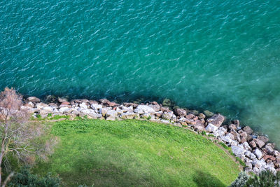 High angle view of rocks by sea