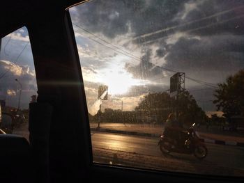 Silhouette of person riding bicycle on road