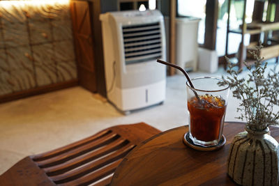 Close up iced black coffee on wooden table