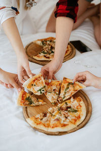 Midsection of woman holding pizza