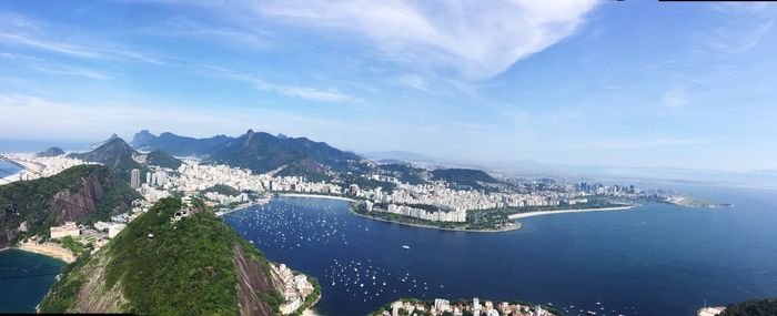 High angle view of city and sea against sky