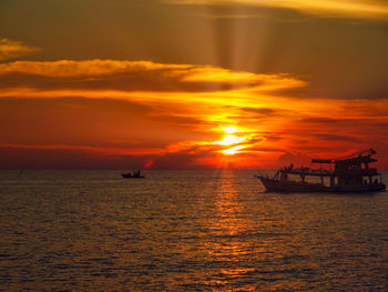 Scenic view of sea against orange sky