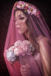 Midsection of woman holding pink flower bouquet