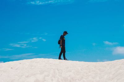 Rear view of man standing on beach