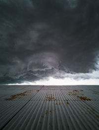 Scenic view of sea against storm clouds