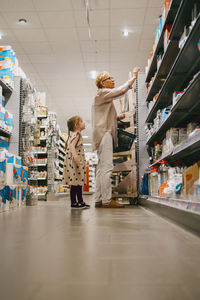 Grandmother and granddaughter doing shopping at supermarket