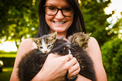 Close-up of woman holding cats 