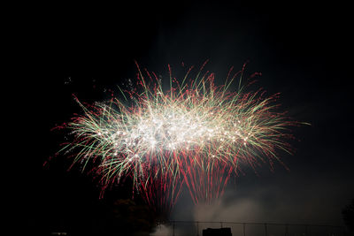 Low angle view of firework display at night