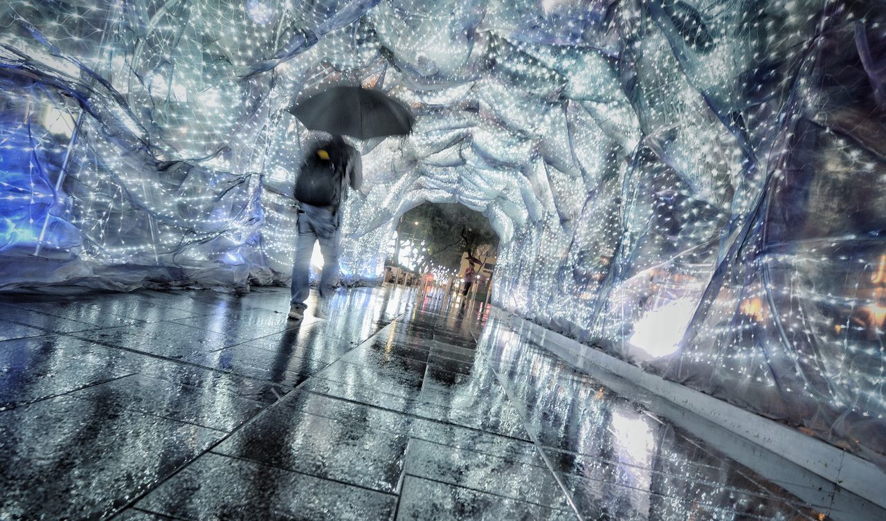 WOMAN IN ILLUMINATED AQUARIUM DURING WINTER