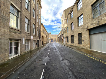 View down, scoresby street, with stone built victorian warehouse in, little germany, bradford, uk