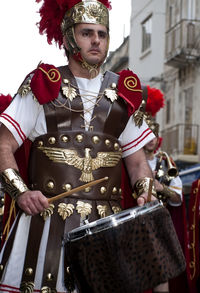 Portrait of man standing in traditional clothing